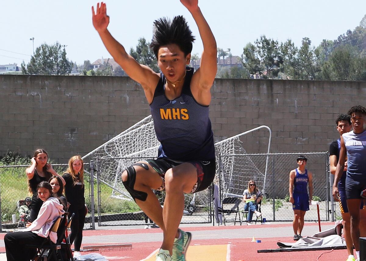 Marina's Khang Nguyen competes in the triple jump at the Orange County track and field championships at Mission Viejo High.