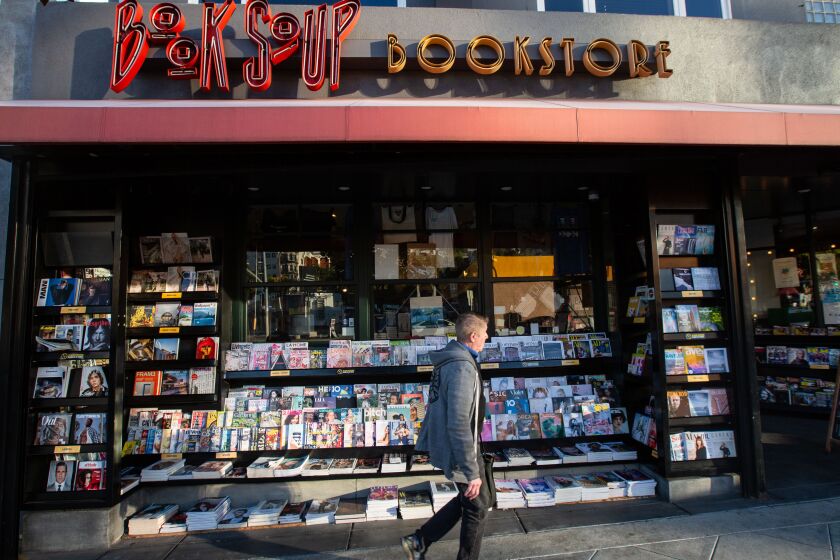 Los Angeles, CA., February 6, 2020 — People walk past Book Soup Book Store on Thursday, February 6, 2020 in Los Angeles, California. (Jason Armond / Los Angeles Times)
