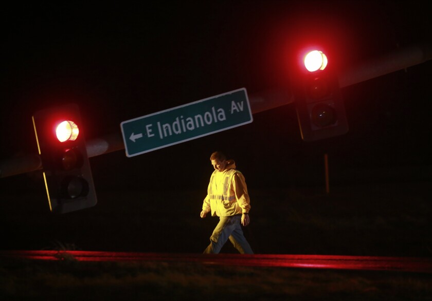A utility worker tends to a downed stoplight on Highway 69 in Des Moines, Iowa, on Saturday, March 5, 2022, after a strong storm caused damage in areas of central Iowa. (Bryon Houlgrave/The Des Moines Register via AP)