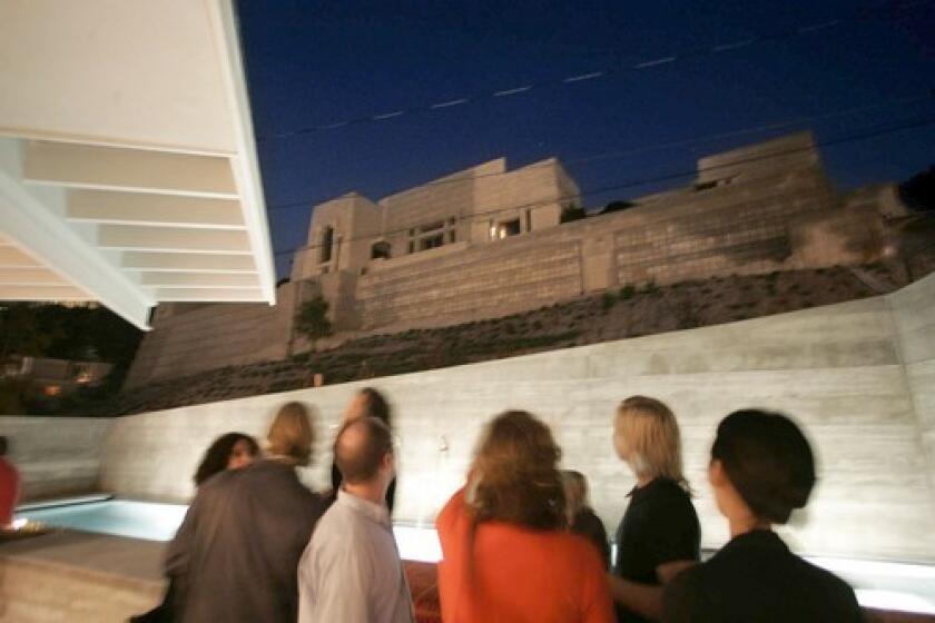 Architect Barbara Bestor built her latest house on a Los Feliz promontory across the street from the iconic 1924 Ennis House, Frank Lloyd Wright's fourth and final textile-block house in Los Angeles. "It is L.A.'s Machu Picchu," Bestor says. At a party to honor her friend David Weeks, the furniture and lighting designer, guests look at a concrete wall angled to create the illusion of a pedestal for the Ennis House.