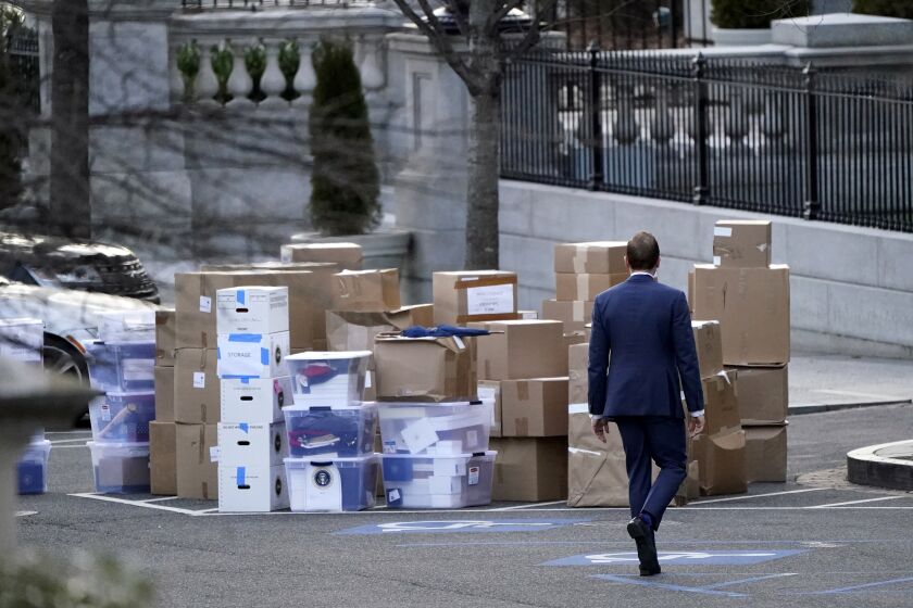 FILE - A man walks past boxes that were moved out of the Eisenhower Executive Office building, just outside the West Wing, inside the White House complex, Jan. 14, 2021, in Washington. At least three presidents. A vice president, a secretary of state, an attorney general. The mishandling of classified documents is not a problem unique to President Joe Biden and former President Donald Trump.(AP Photo/Gerald Herbert, File)