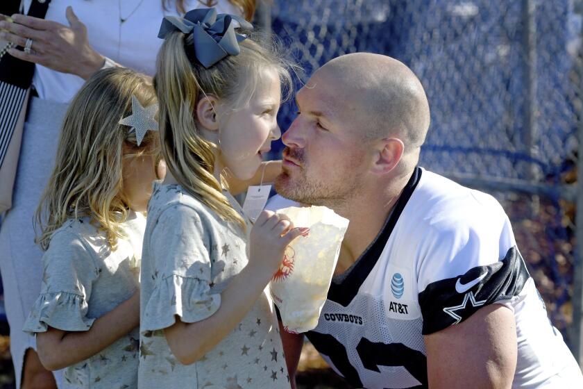 Camps allow for casual time with players -- and family. Dallas Cowboys tight end Jason Witten, back in the NFL after a brief retirement, greets his daughters, Landry, 6, and Hadley, 4, in Oxnard.