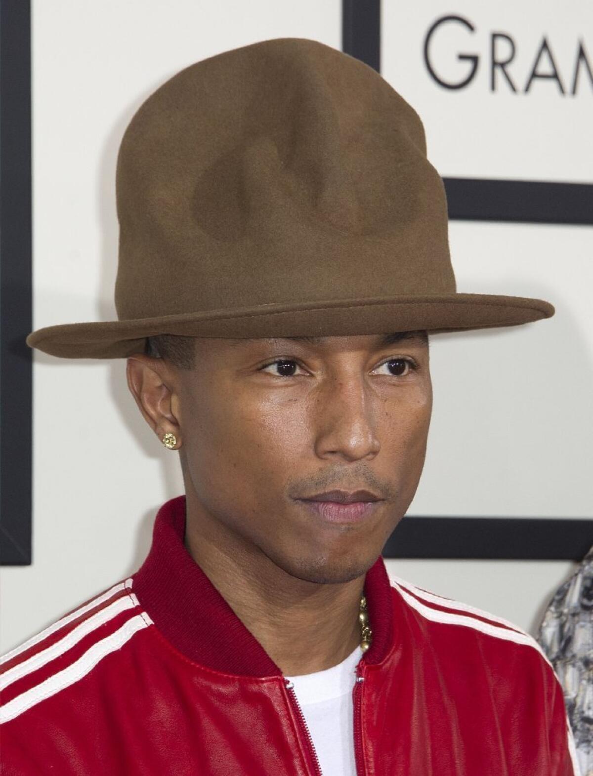 Recording artist Pharrell Williams sports a Vivienne Westwood "Mountain" hat on the Grammy Awards red carpet. The high-profile headgear went viral, earning comparisons to Smokey Bear and the Arby's logo and spawning a parody Twitter account from the hat's point of view.