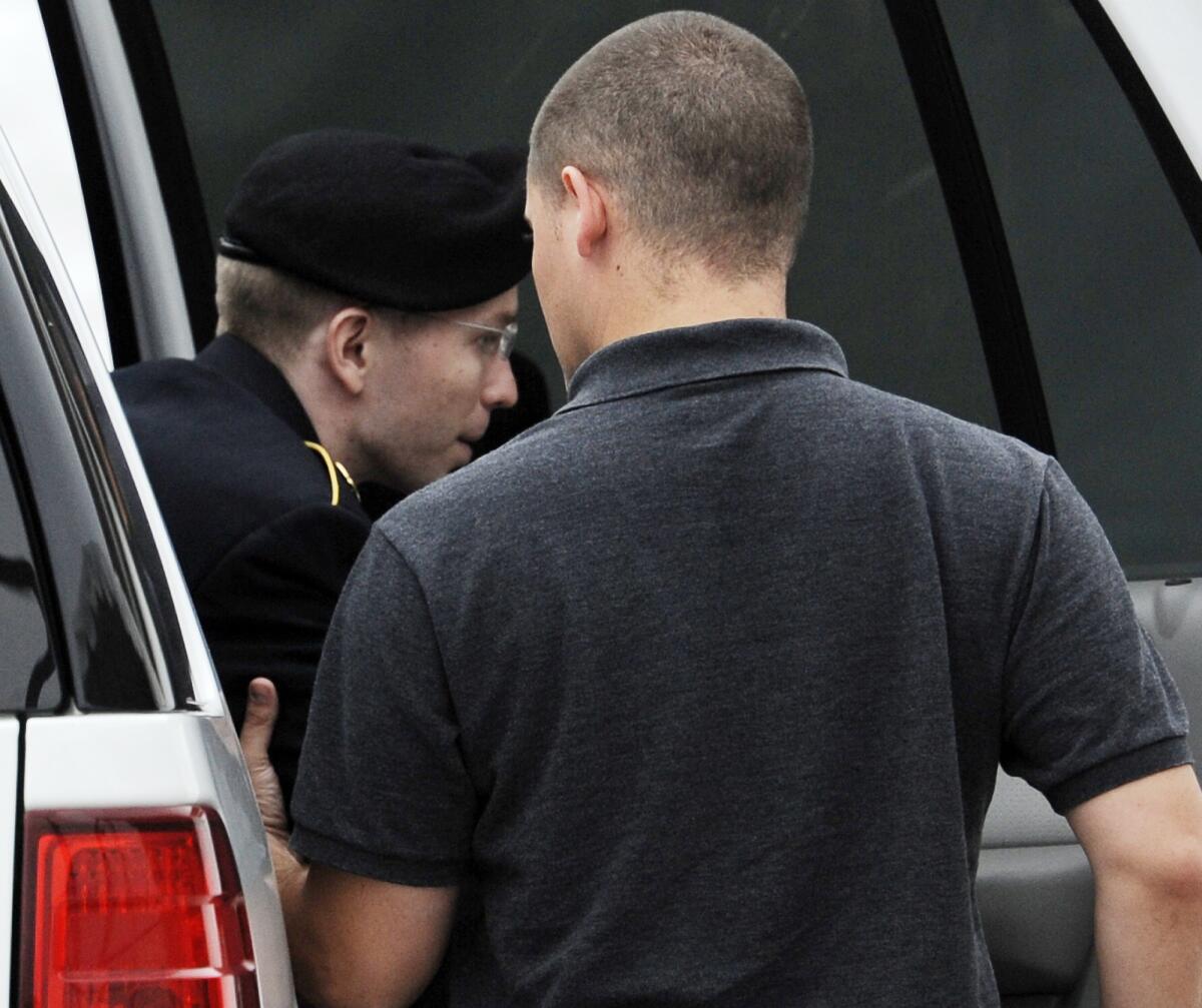 Army Pfc. Bradley Manning is escorted into a courthouse for his court marial at Fort Mead, Md., on Thursday.
