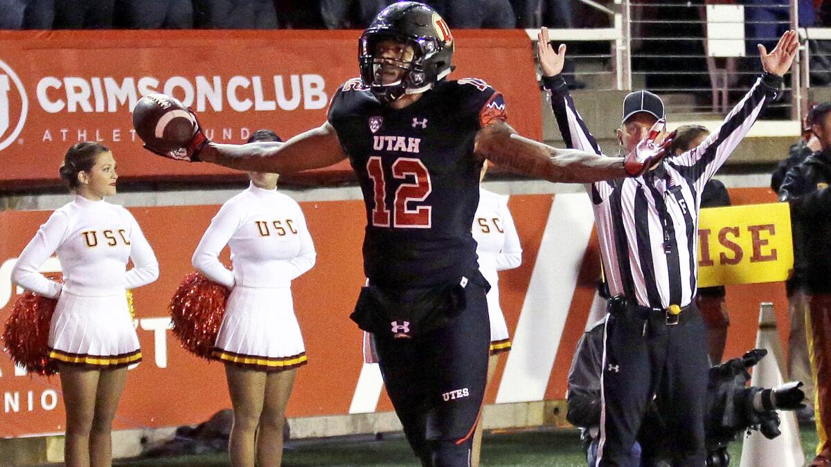 Utah wide receiver Tim Patrick (12) celebrates after catching the winning touchdown against USC on Friday night.