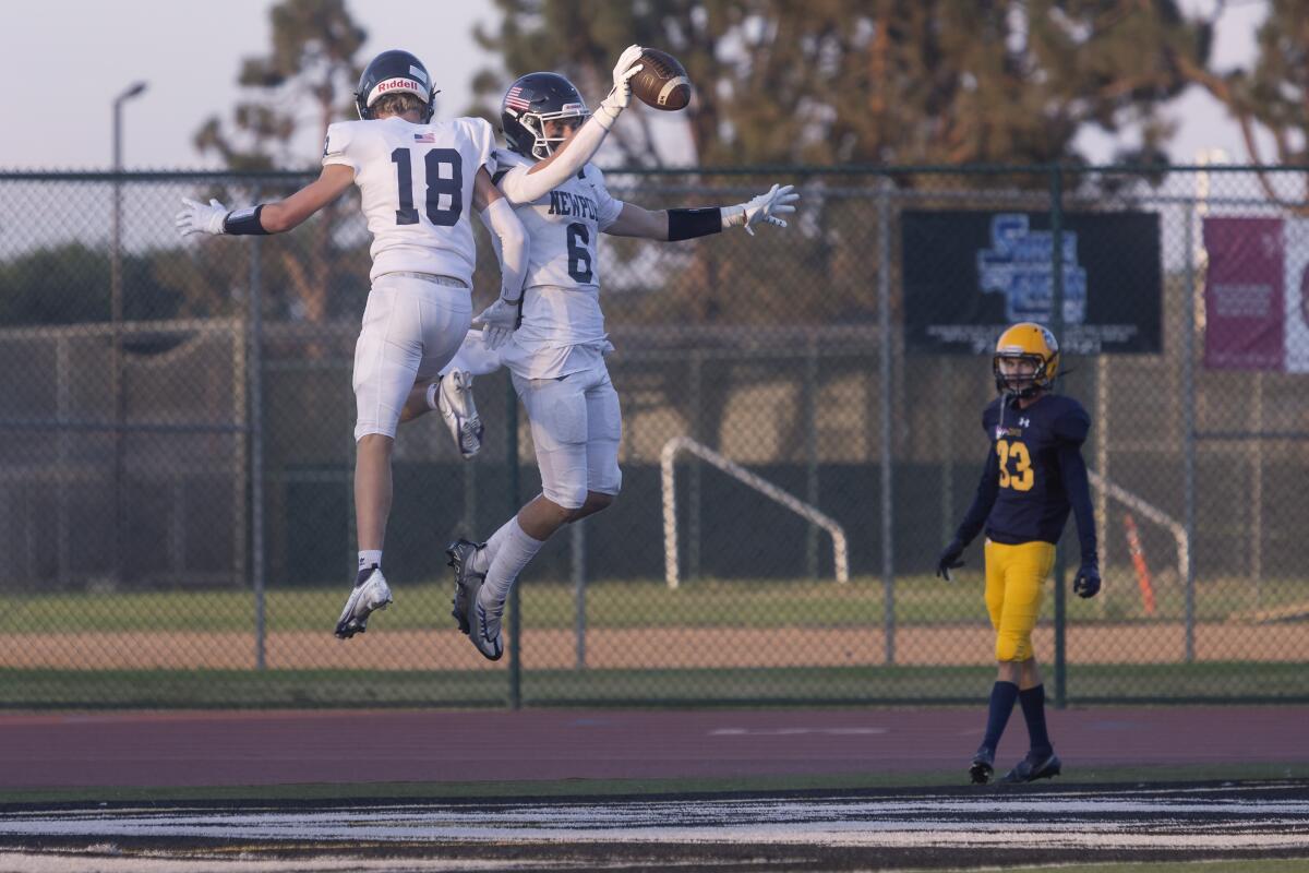 From left, Newport Harbor's Tommy Robinson and Kashton Henjum celebrate after scoring a touchdown against Marina. 