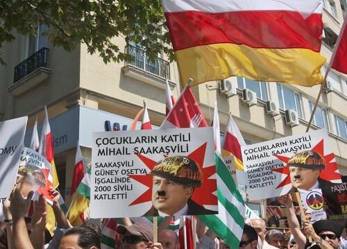 Supporters of Russian-backed rebel regions Abkhazia and South Ossetia hold up placards during a demonstration in front of the Georgia Consulate in Istanbul.