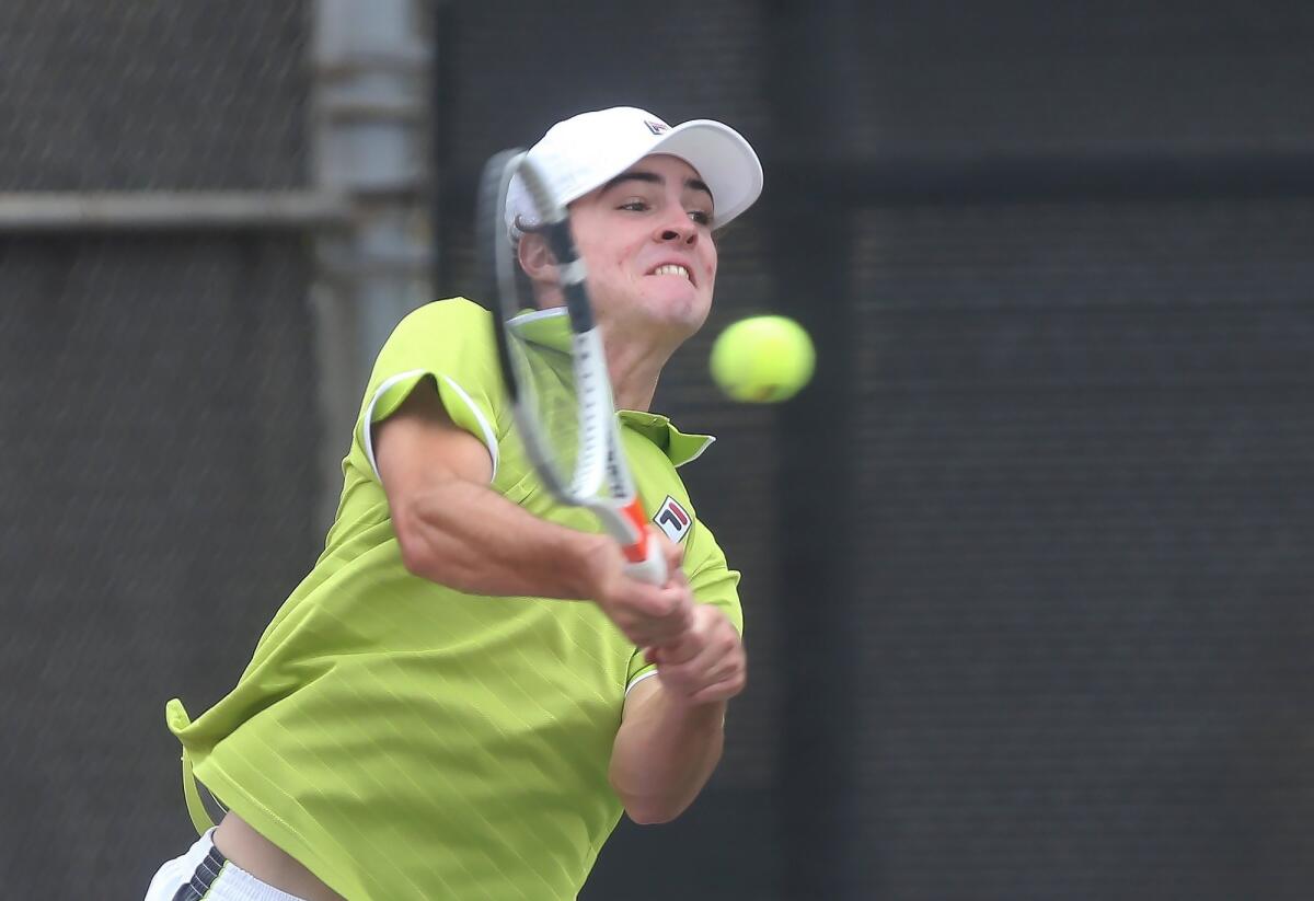 Jett Cole of Laguna Beach hits a backhand winner against Jean-Baptiste Badon of Sunland in the boys' 18-and-under round of 16 singles match at the USTA Southern California Junior Sectional Championships at Costa Mesa Tennis Center on Friday.