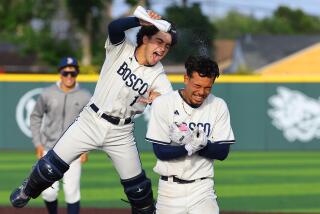 St. John Bosco's Moises Razo receives a water bottle soaking from Aaron Garcia after delivering the game-winning.