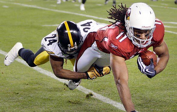 Arizona Cardinals quarterback Kurt Warner argues with a referee as Arizona  Cardinals wide receiver Larry Fitzgerald looks on in the third quarter  against the Pittsburgh Steelers at Super Bowl XLIII at Raymond