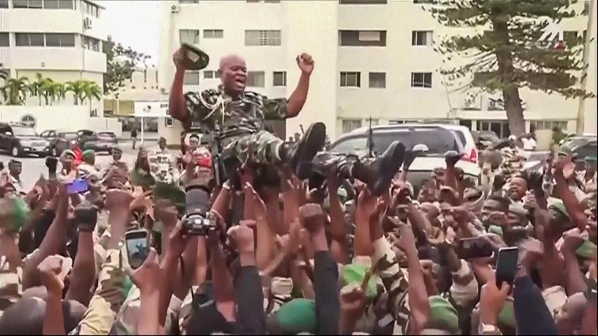 Gabonese general held aloft by supporters