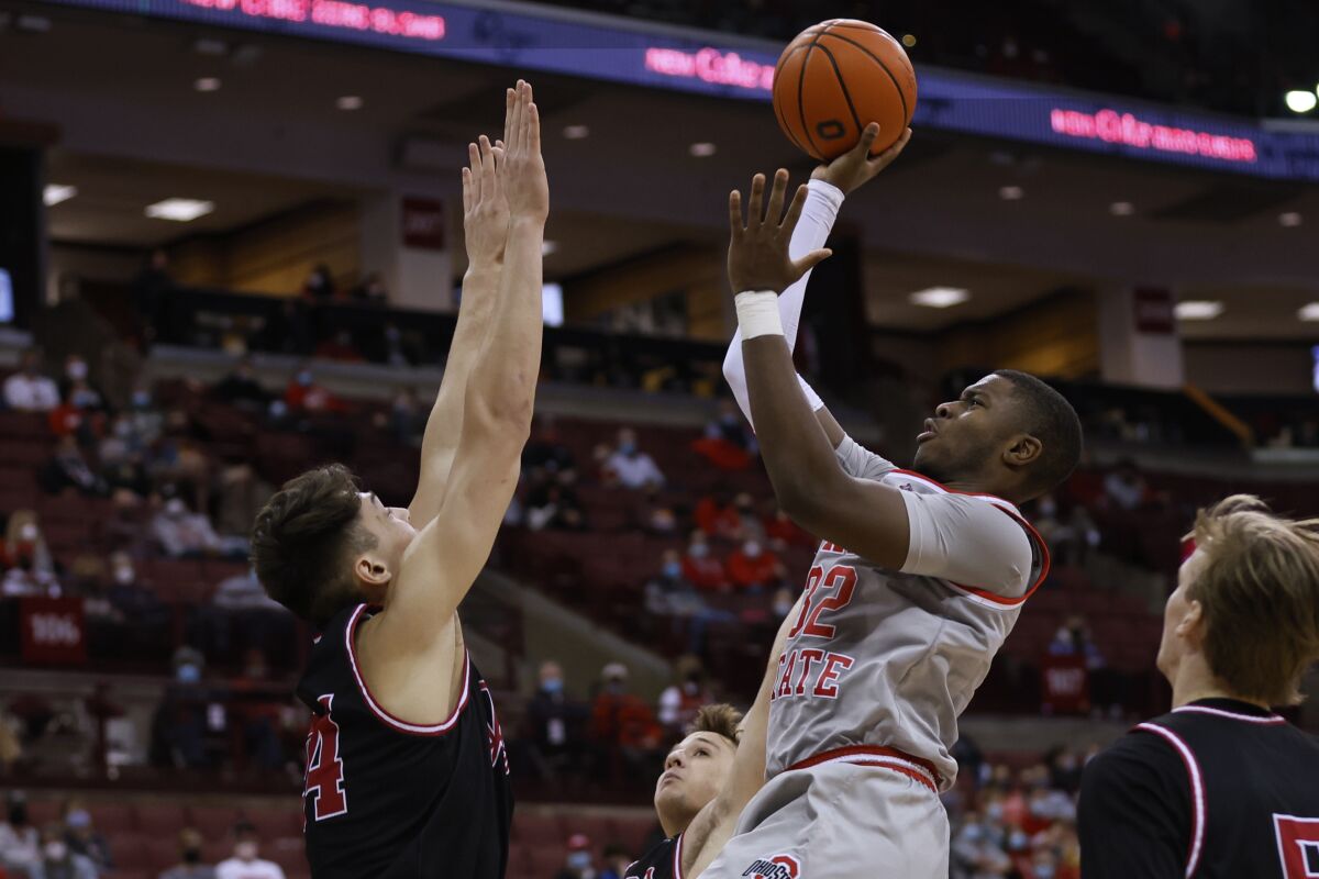 Ohio State's E.J. Liddell, right, shoots as IUPUI's Jonah Carrasco defends during the second half of an NCAA college basketball game Tuesday, Jan. 18, 2022, in Columbus, Ohio. (AP Photo/Jay LaPrete)