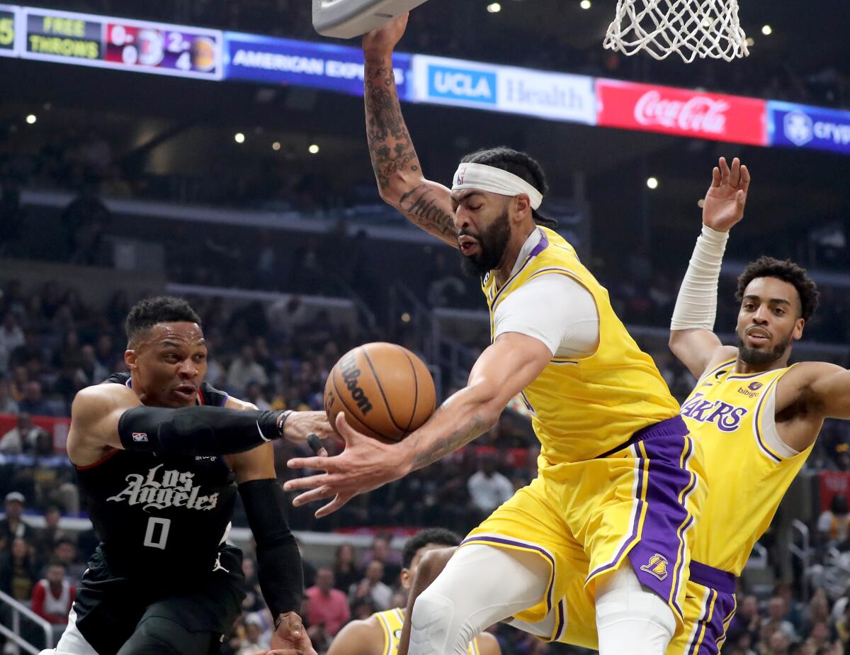 Clippers guard Russell Westbrook turns the ball over to Lakers power forward Anthony Davis at Crypto.com Arena.