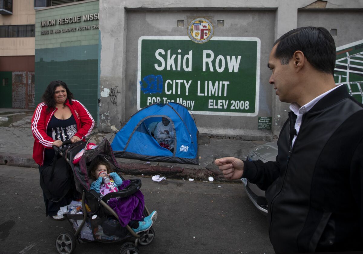 In front of a small tent pitched on L.A.'s skid row, a woman and child are approached by a politician