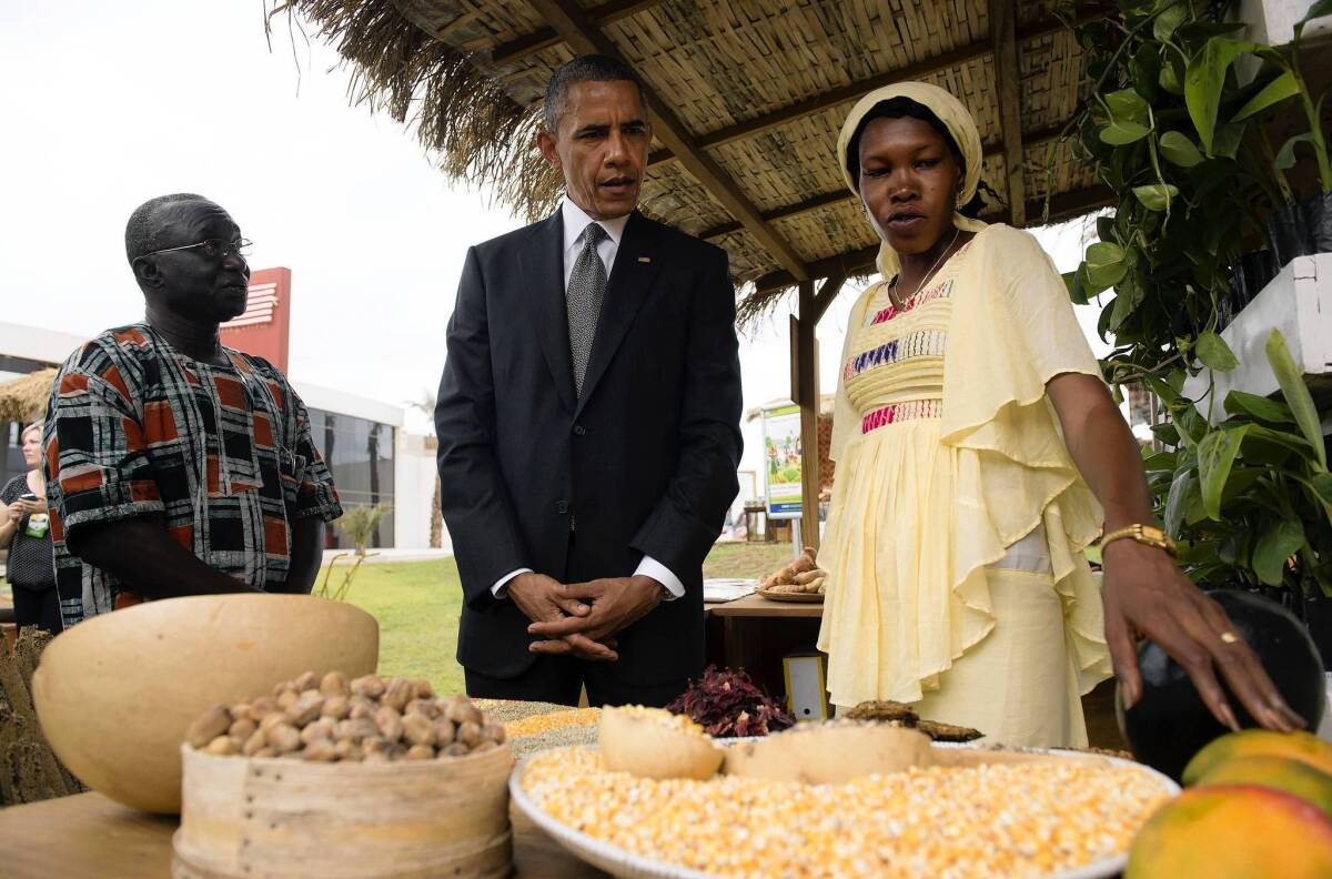 President Obama visits with Papa Sene, left, of the National Cooperative Business Assn. and Oumou Gadio during an event in Dakar, Senegal, focusing on food security in Africa.