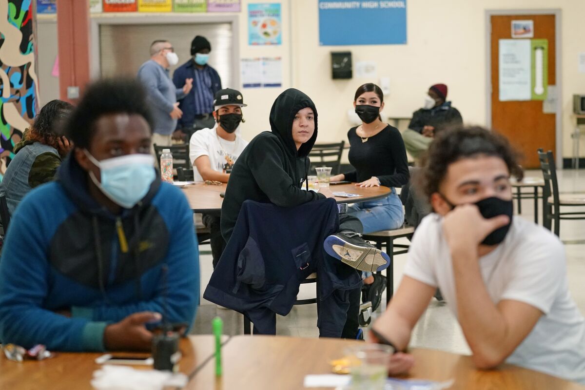 Students at West Brooklyn Community High School in New York listen to their principal in the school's cafeteria on Oct. 29.