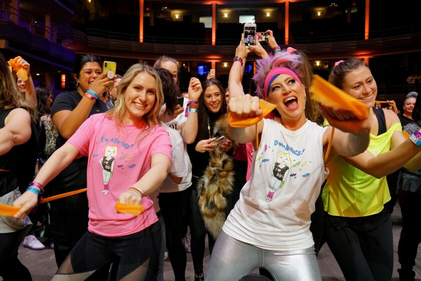 "Real Housewives of New York City" cast member Dorinda Medley, right, is surrounded by fans while leading an aerobics class at the first ever BravoCon.