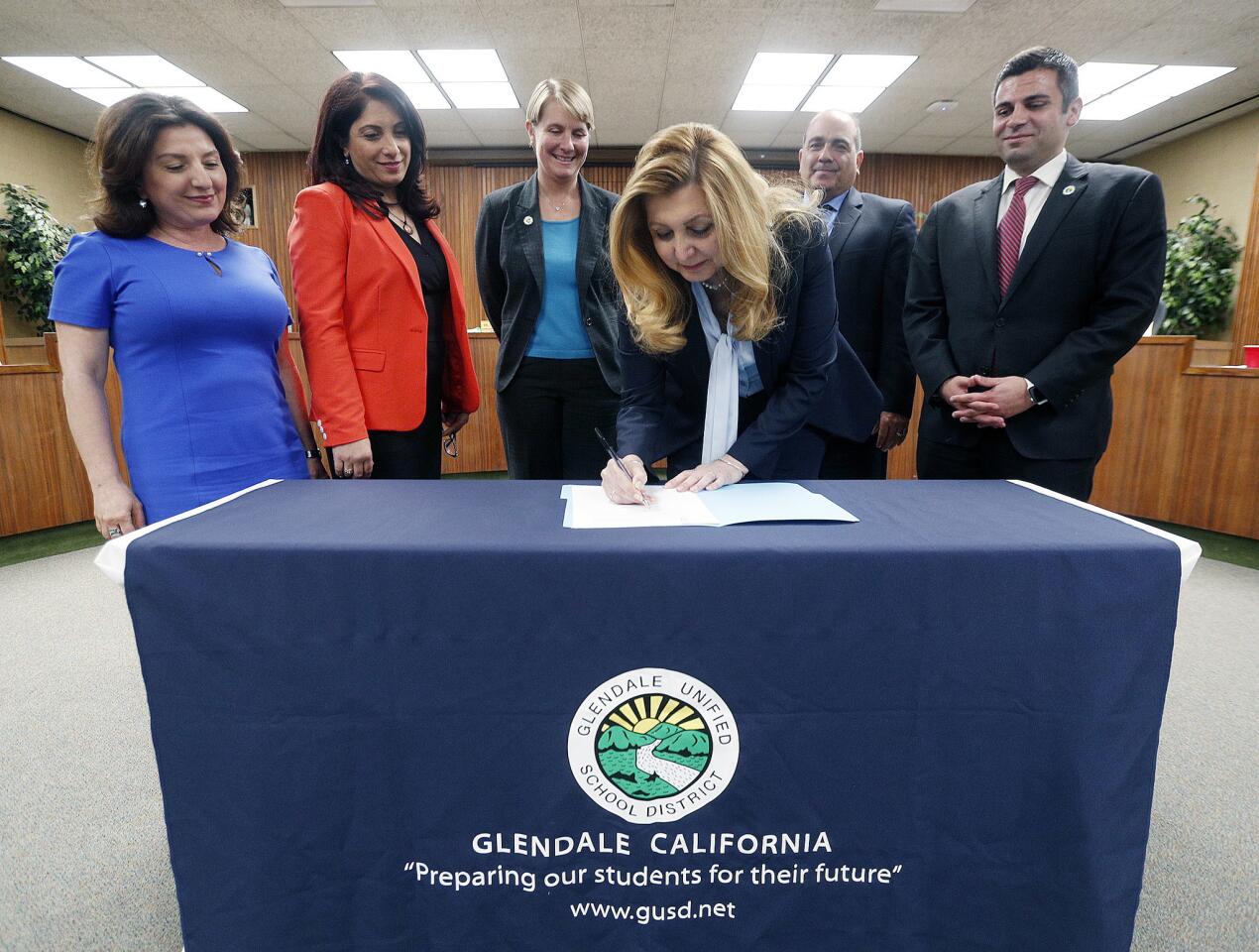 Superintendent Vivian Ekchian signs her contract with the Glendale Unified School Board behind her at the vote and approval of the new Glendale Unified School District Superintendent Vivian Ekchian in the Glendale Unified School District board room in Glendale on Tuesday, May 21, 2019. Ekchian is a Glendale resident and Los Angeles Unified School District Deputy Superintendent.. She will be the first Armenian and first female in school district history and would become the 18th superintendent since 1913.