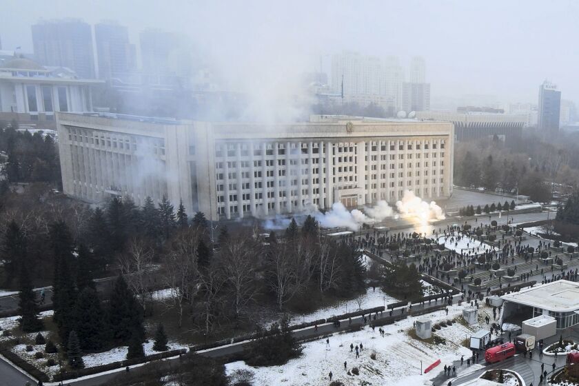 Smoke rises from the city hall building during a protest in Almaty, Kazakhstan, Wednesday, Jan. 5, 2022. News outlets in Kazakhstan are reporting that demonstrators protesting rising fuel prices broke into the mayor's office in the country's largest city and flames were seen coming from inside. Kazakh news site Zakon said many of the demonstrators who converged on the building in Almaty on Wednesday carried clubs and shields. (AP Photo/Yan Blagov)