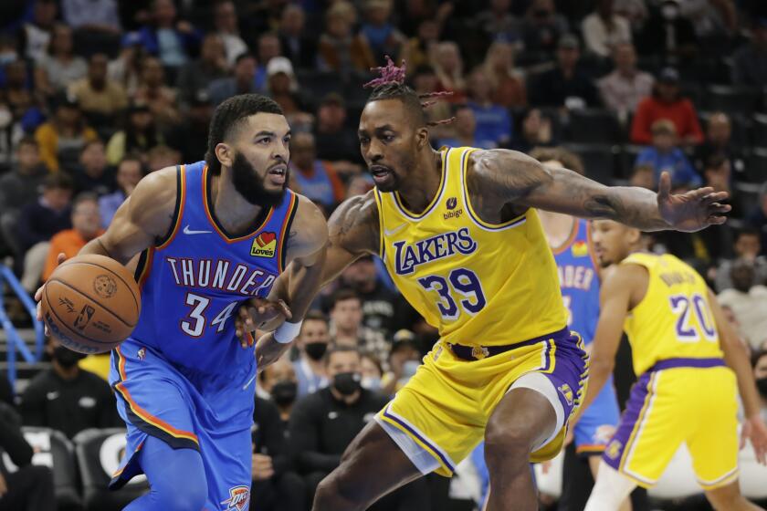 Oklahoma City Thunder forward Kenrich Williams (34) goes against Los Angeles Lakers center Dwight Howard (39) during the second half of an NBA basketball game, Wednesday, Oct. 27, 2021, in Oklahoma City. (AP Photo/Garett Fisbeck)