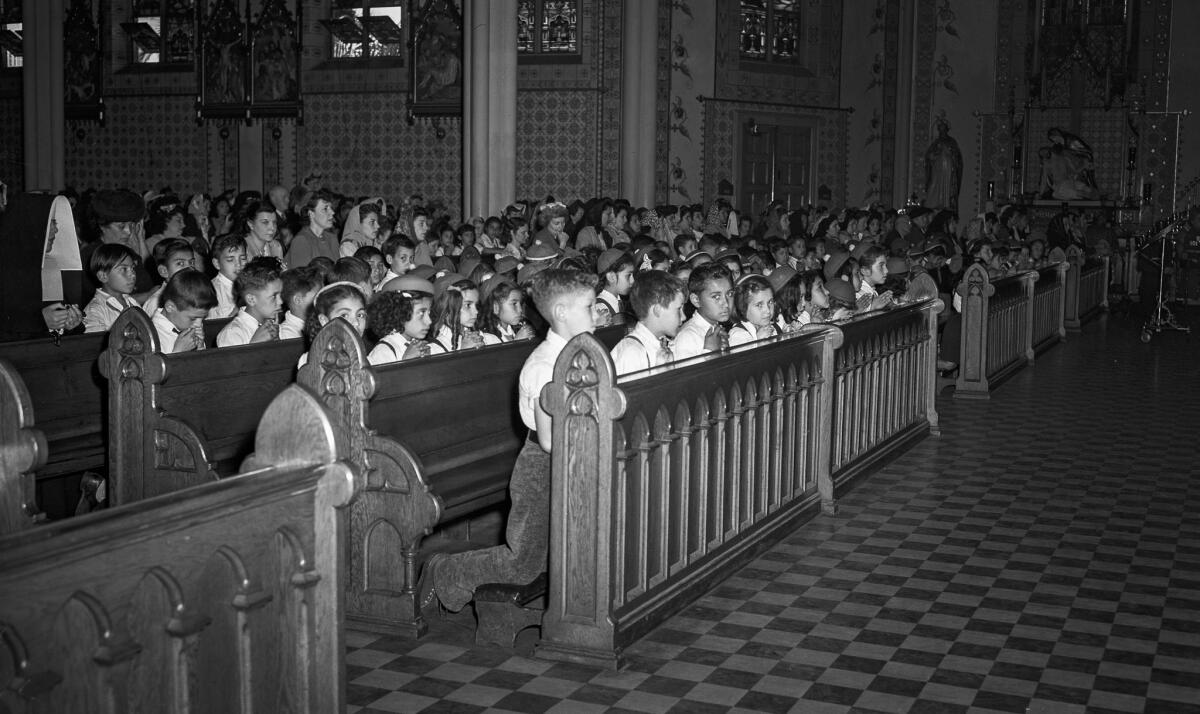 June 6, 1944: Children participate in a noontime prayer service at St. Joseph Church at 12th and Los Angeles streets on D-day.