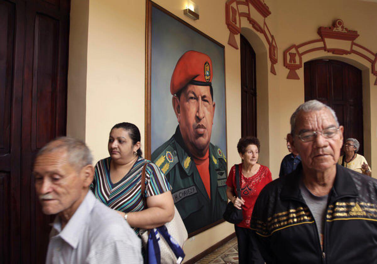 A painting of Venezuela's late President Hugo Chavez in a military uniform hangs near his tomb at the Military Museum in Caracas, Venezuela.
