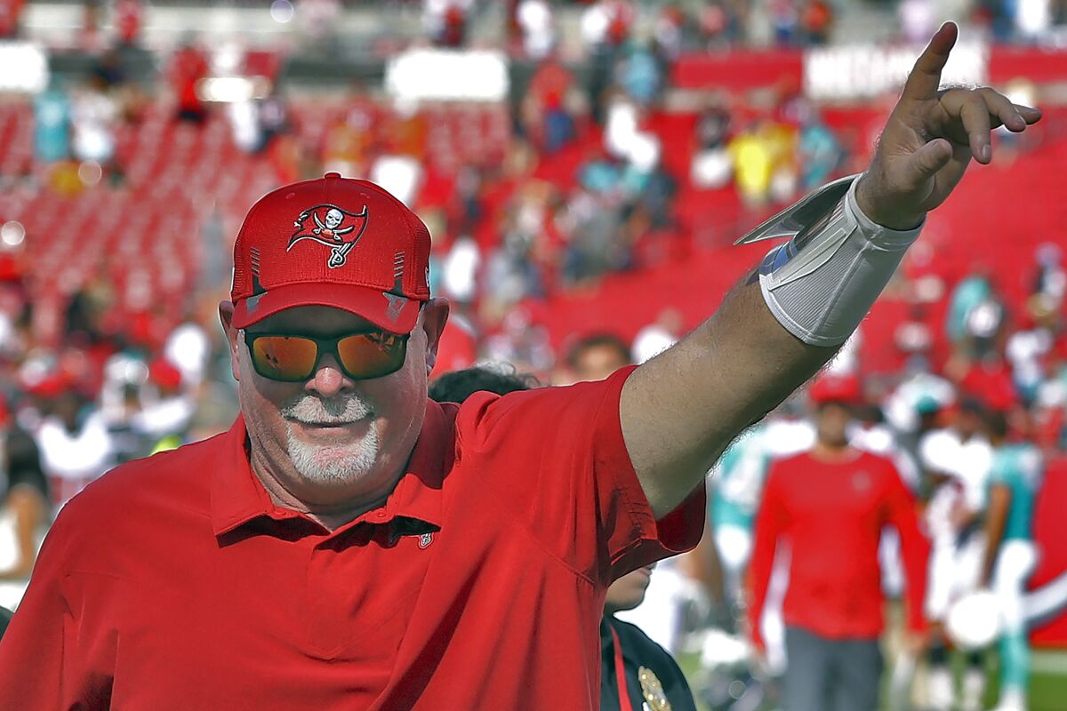 Tampa Bay Buccaneers head coach Bruce Arians celebrates as he leaves the field after an NFL football game against the Miami Dolphins Sunday, Oct. 10, 2021, in Tampa, Fla. (AP Photo/Mark LoMoglio)