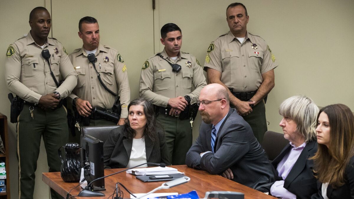Louise Turpin, left, and David Turpin, second from right, pleaded not guilty to charges of multiple counts of torture, child abuse, abuse of dependent adults and false imprisonment at the Riverside Hall of Justice.