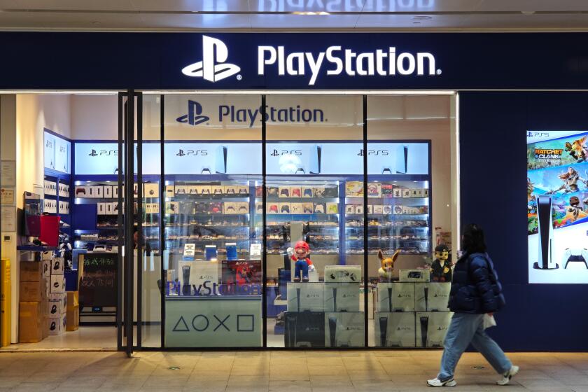 A pedestrian passes a SONY PlayStation game console store in Shanghai, China, 