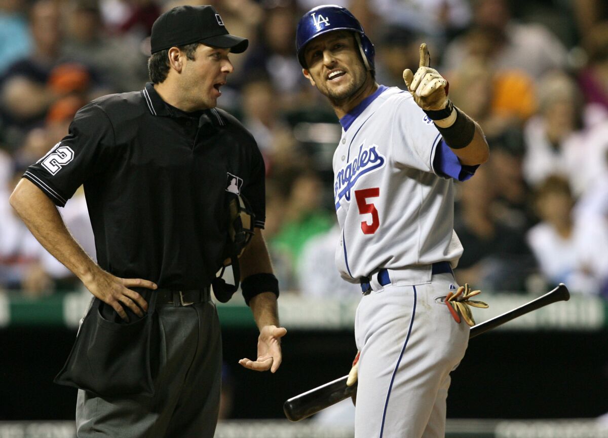Los Angeles Dodgers' Nomar Garciaparra, right, argues with home plate umpire James Hoye after Hoye said Garciaparra struck out on a check swing to end the top of the eighth inning of a baseball game against the Colorado Rockies, Friday, June 9, 2006, in Denver. Los Angeles won 3-0.