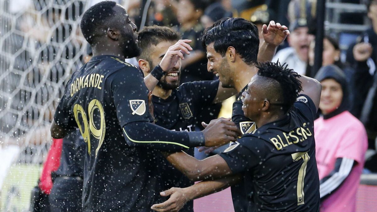 Carlos Vela, being congratulated by teammates, and LAFC had a record-setting season in 2019.