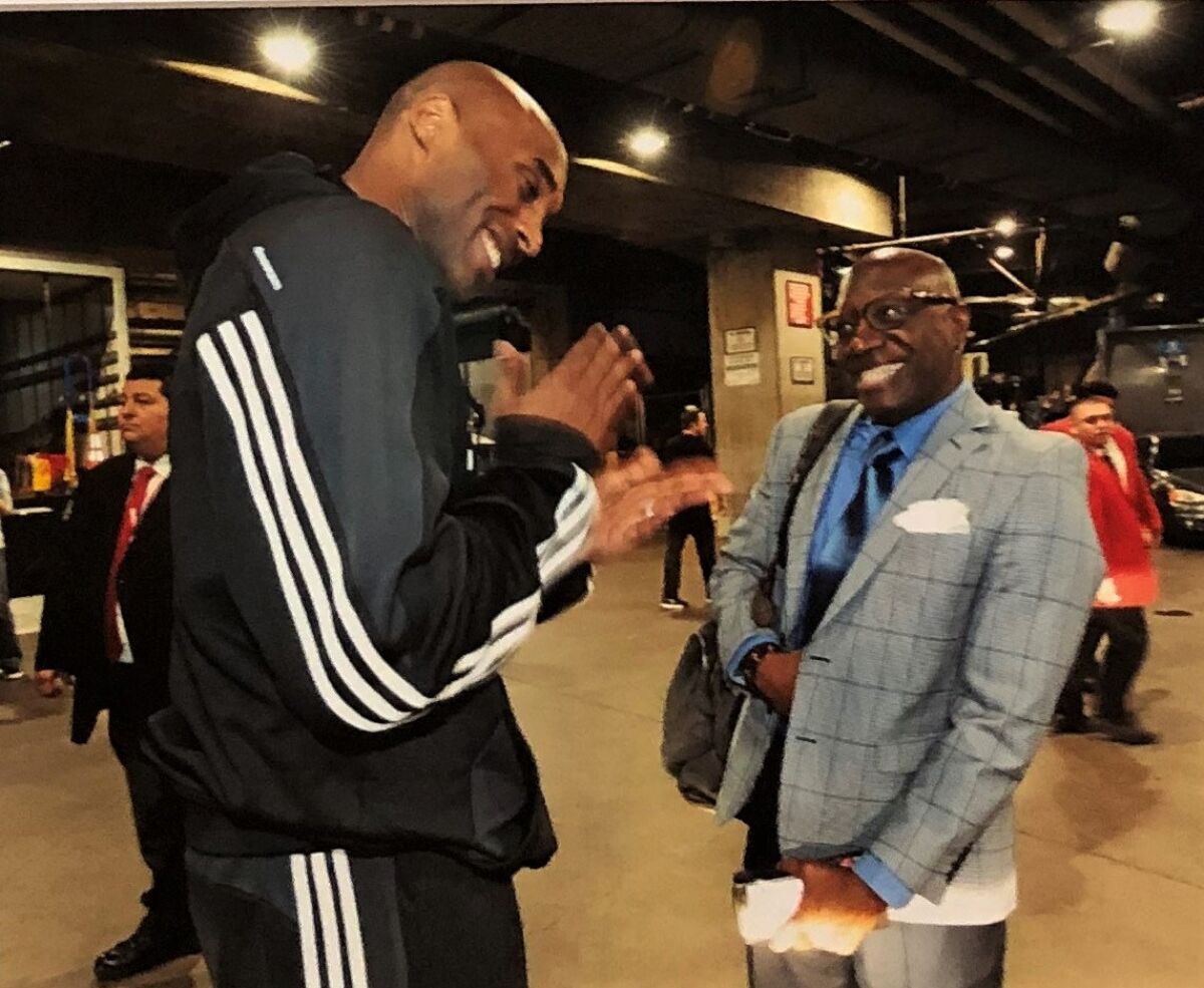 Lakers star Kobe Bryant and Times reporter Broderick Turner chat after Bryant's 60-point farewell game on April 13, 2016.