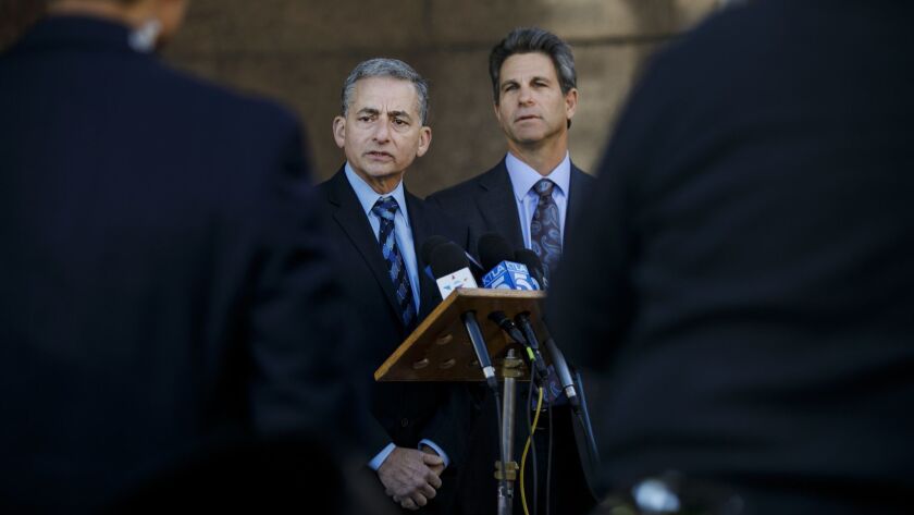 Former Beverly Hills Police Capt. Mark Rosen, left, speaks at a news conference with attorney Brad Gage announcing his $2.3-million settlement with the city.