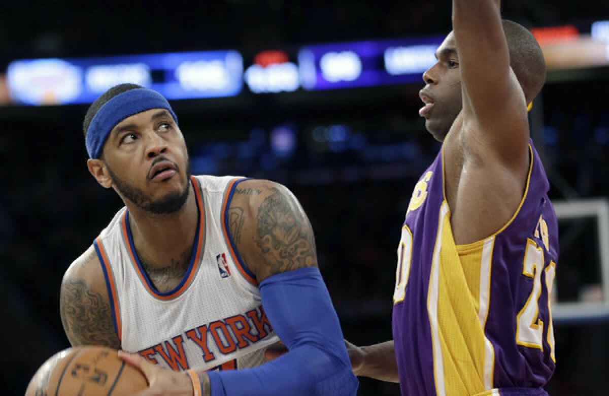 Knicks forward Carmelo Anthony eyes the basket as Lakers guard Jodie Meeks plays tight defense during L.A.'s 110-103 loss on Jan. 26.