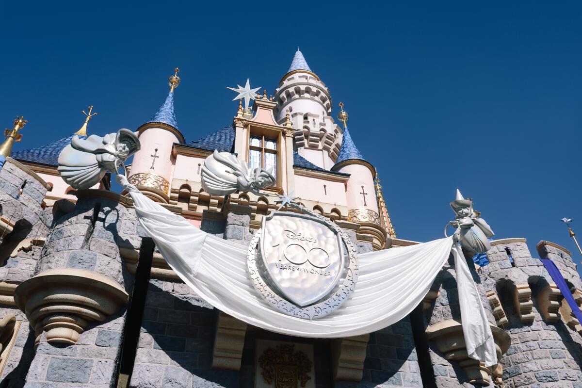 A sign on the Sleeping Beauty Castle at Disneyland celebrates the Anaheim theme park’s 100th anniversary this year. 