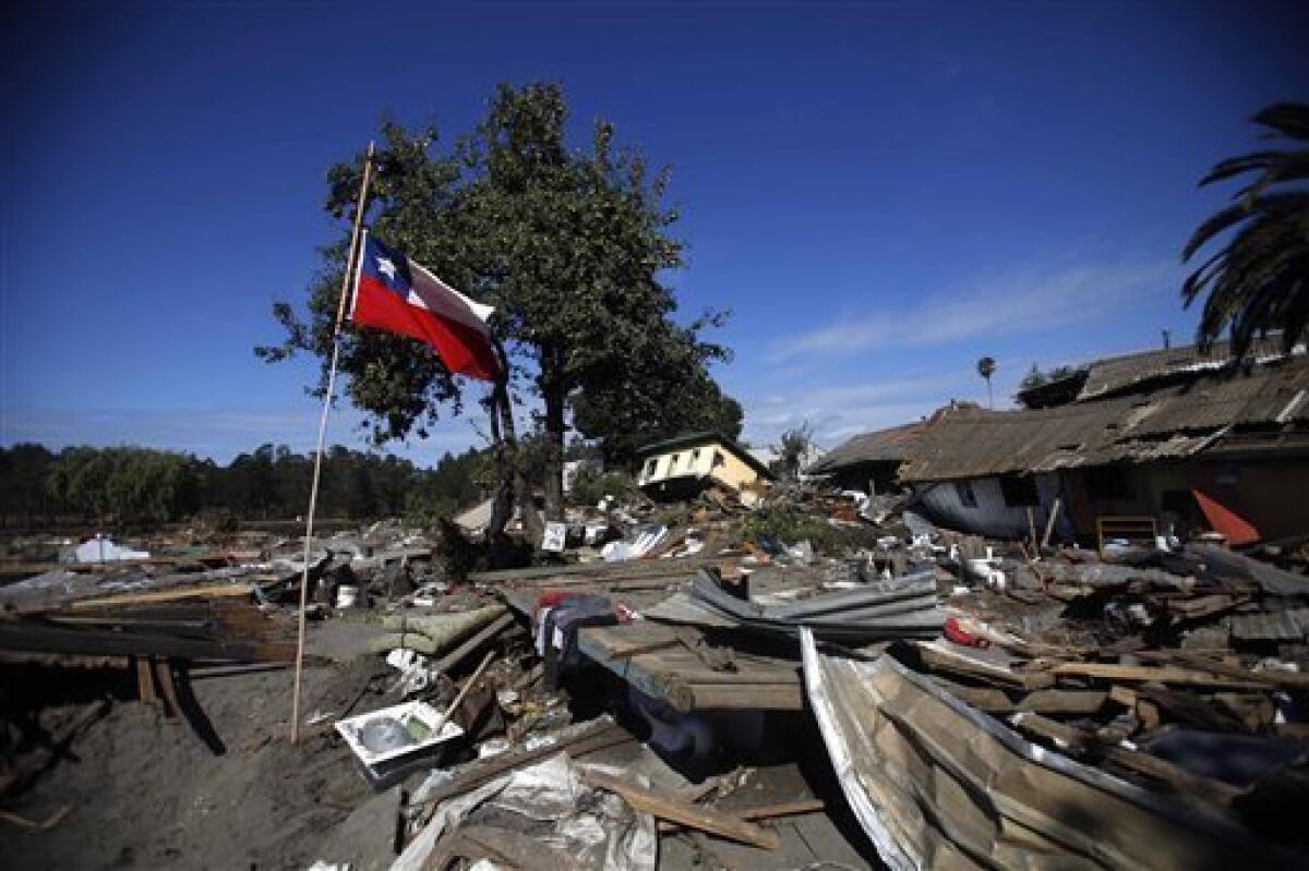 A Chilean flag waves at an earthquake area in Constitucion, Chile, Tuesday, March 2 , 2010. An 8.8-magnitude earthquake hit Chile early Saturday, causing widespread damage. (AP Photo/ Roberto Candia)