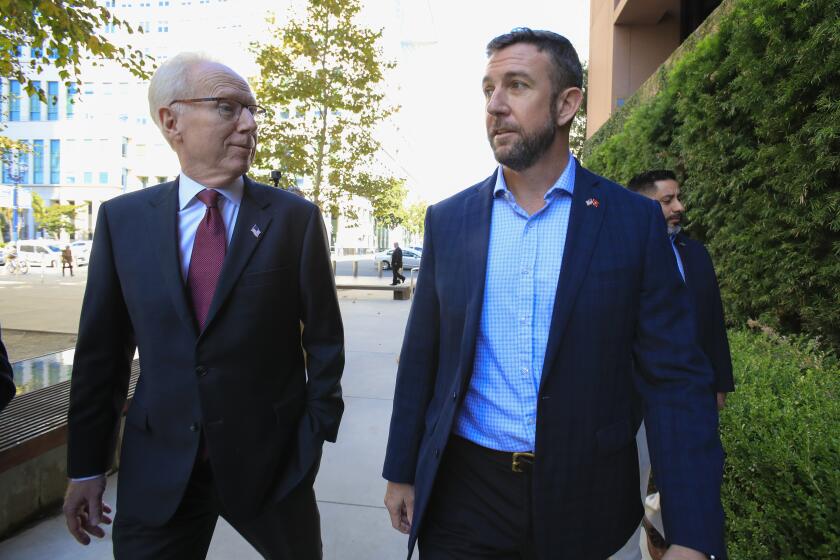 Congressman Duncan Hunter arrives to Federal Court Monday, Nov. 25, 2019 with his attorney Paul Pfingst. The government wants Pfingst disqualified for an alleged conflict of interest because another attorney at Pfingst's firm represents three witnesses who testified before the grand jury and are expected to to testify at trial.