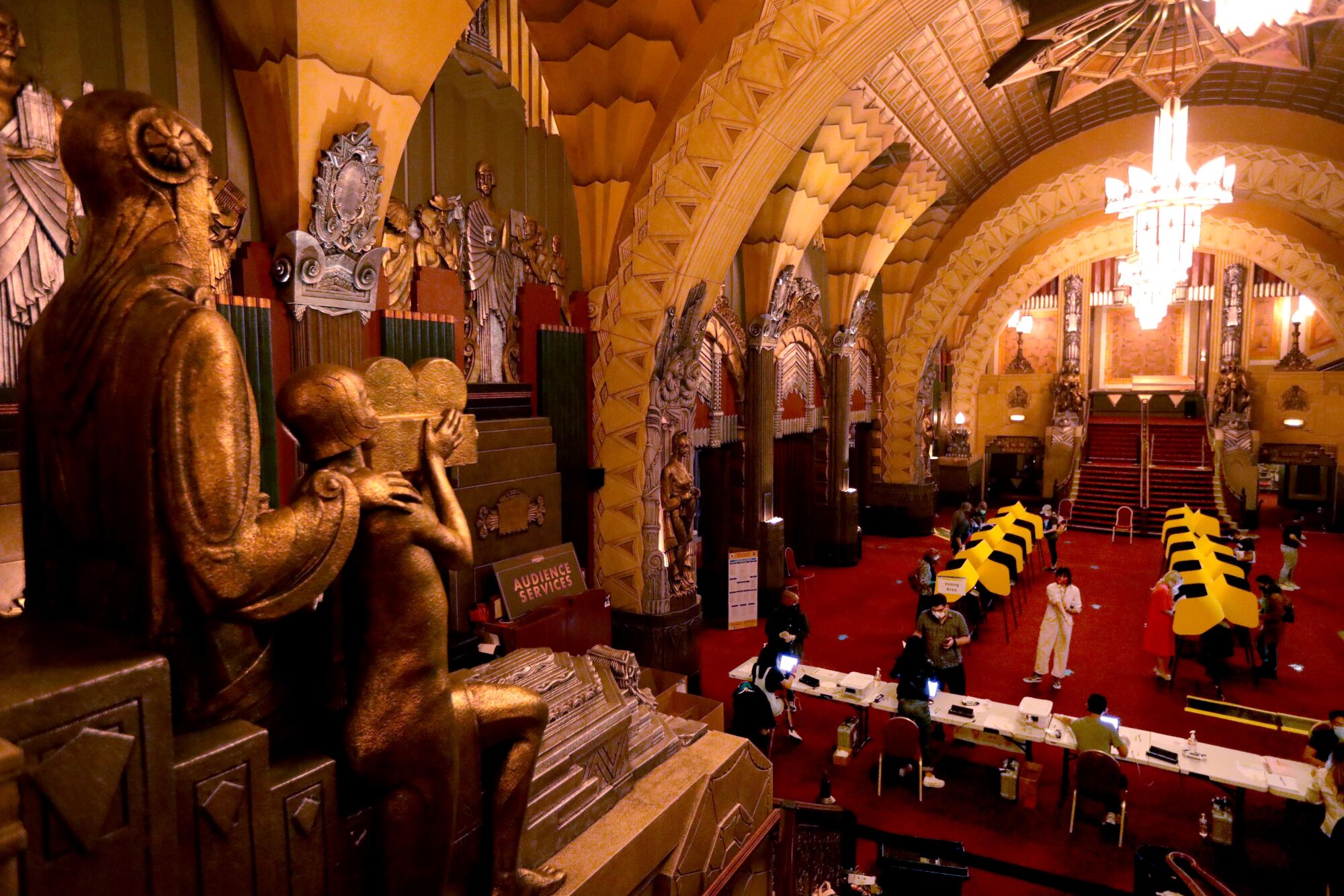 A statue seems to film voters who cast their ballots on election day at the Pantages Theatre in Hollywood.