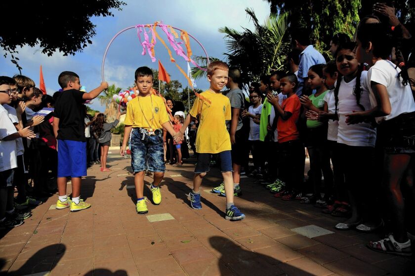 Children hold hands during the first day of school in the costal city of Ashkelon, Israel.