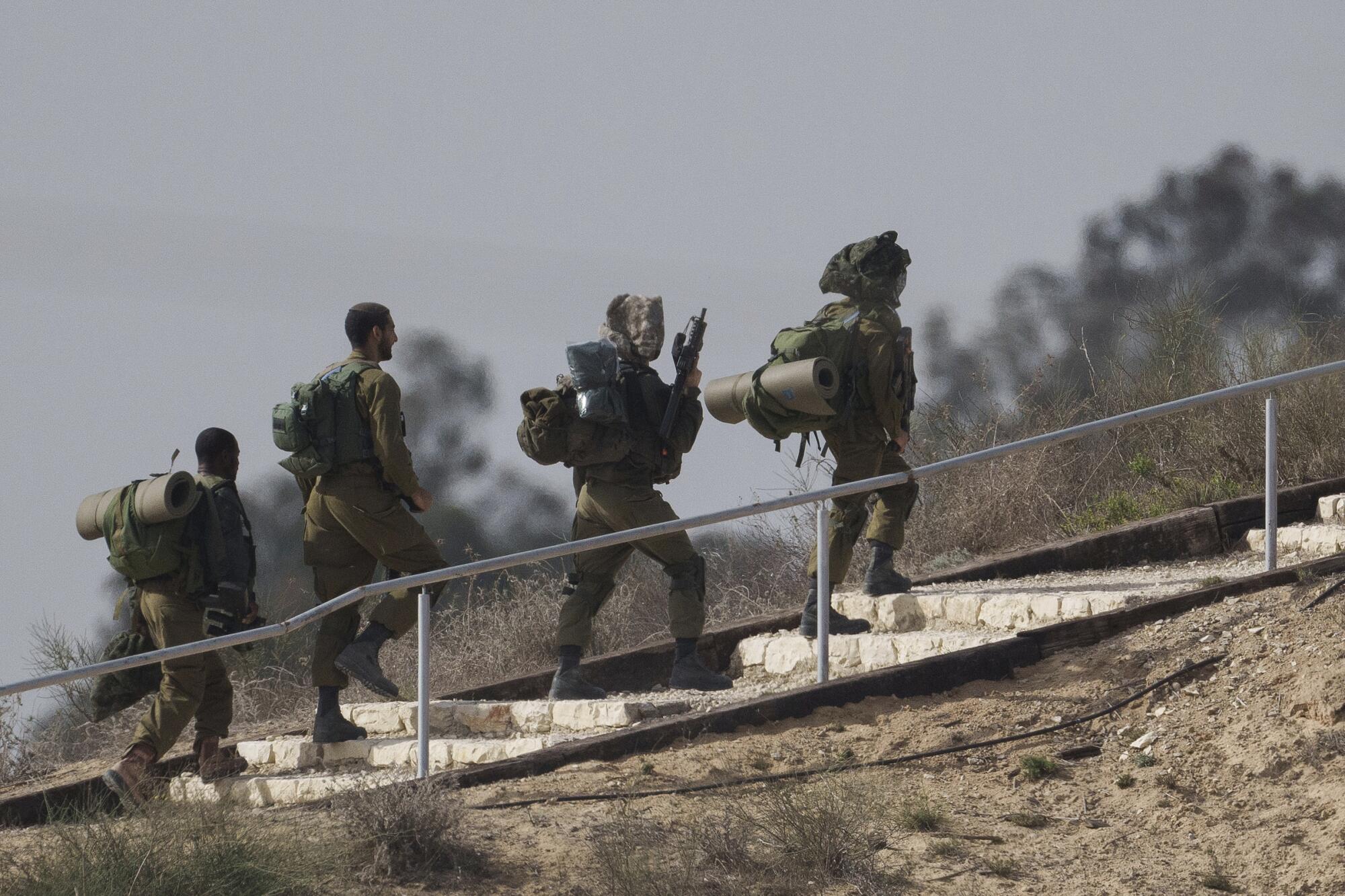 Israeli soldiers walking near the border with the Gaza Strip