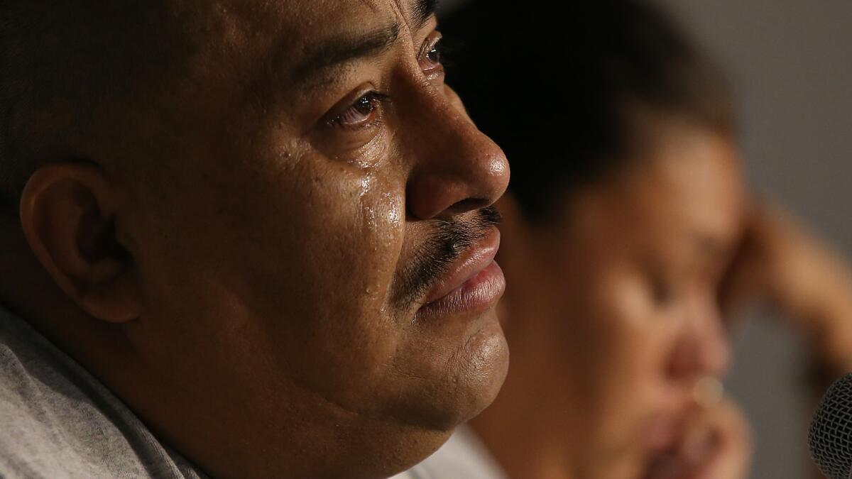 Juan Mendez, the father of Jose Peruzzi Mendez, tears up as he talks about his son during a community meeting.
