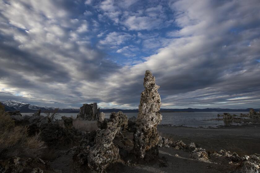 LEE VINING, CA - October 26 2021: Passing clouds provide a striking backdrop for exposed tufa towers along the shore of Mono Lake on Tuesday, Oct. 26, 2021 in Lee Vining, CA. (Brian van der Brug / Los Angeles Times)
