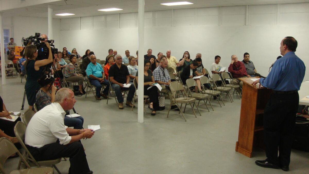 Carlo Uchello, a vice president for Serco, the British company seeking to open a federally contracted immigrant family detention center in Jim Wells County, addresses community members during a public meeting at the county fairgrounds.