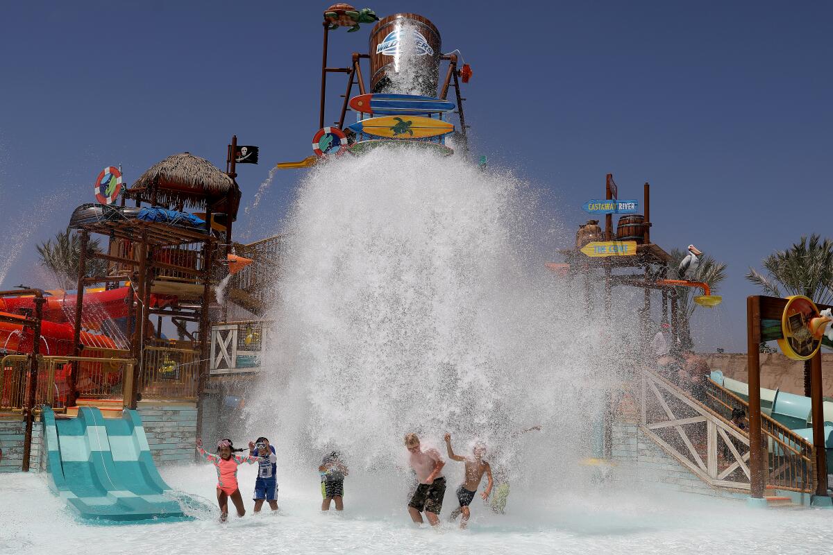 Guests at Wild Rivers water park get splashed by large equipment in 2022.