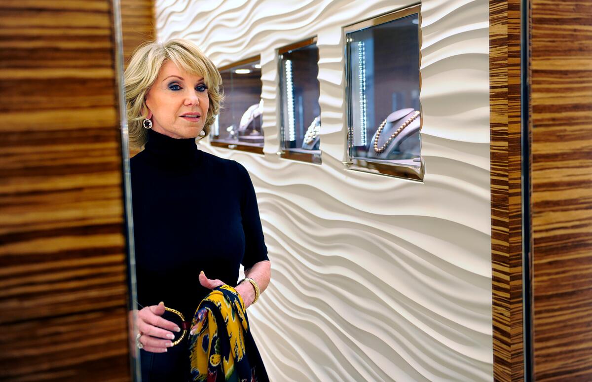 Elaine Wynn looks astatine herself successful a mirror.