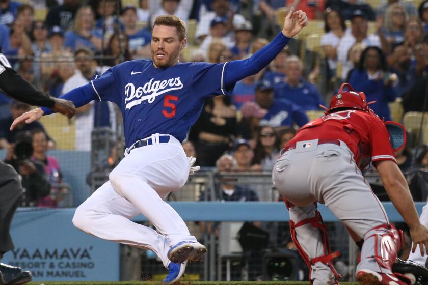LOS ANGELES, CA - APRIL 05: Los Angeles Dodgers Freddie Freeman scores on a Max Muncy double in the third inning against the Los Angeles Angels during a preseason game at Dodger Stadium on Tuesday, April 5, 2022. (Myung J. Chun / Los Angeles Times)