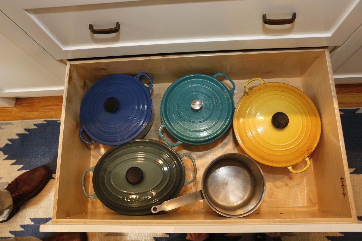 Le Creuset casseroles are stored in a Coastal Cabinets drawer on a reinforced track.