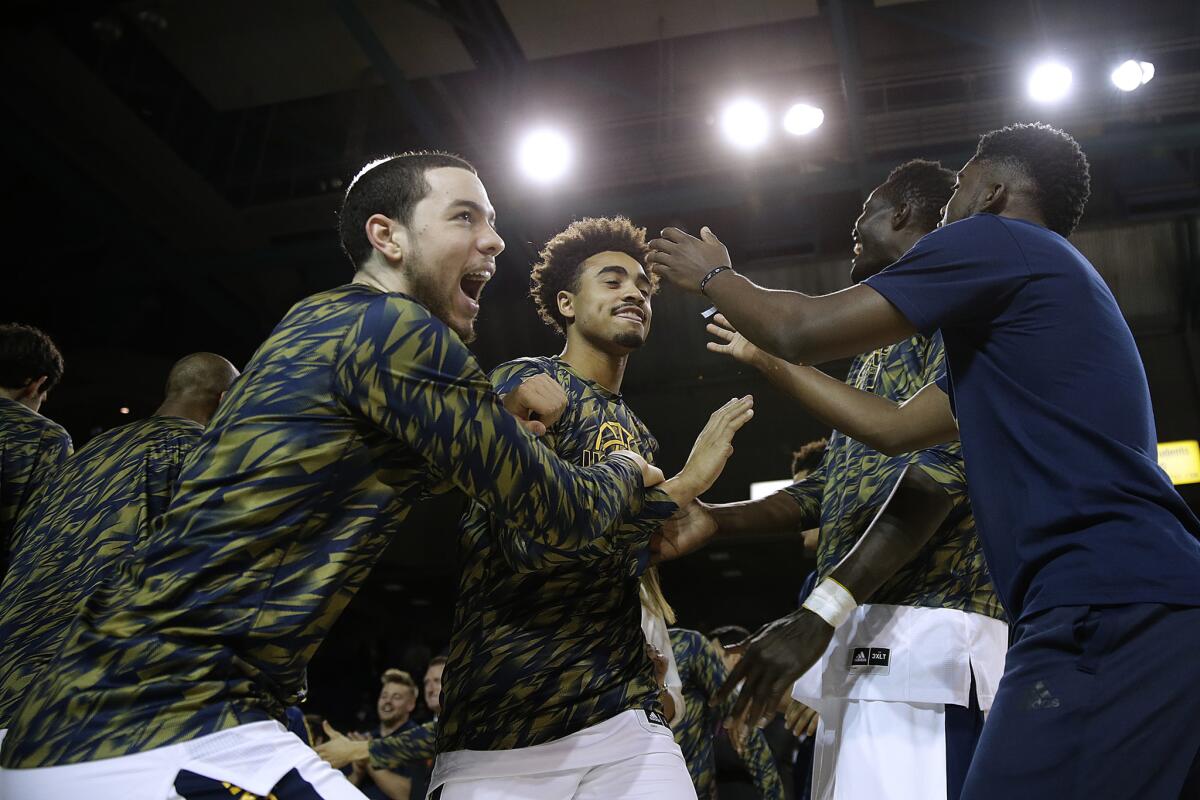 Alex Young is cheered by his UC Irvine teammates as he is introduced before a game against Cal Poly on March 3.