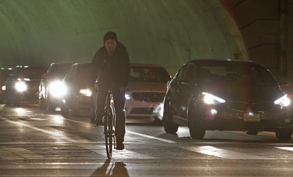 A bike rider using the bike lane comes out of the 2nd Street tunnel in downtown Los Angeles.