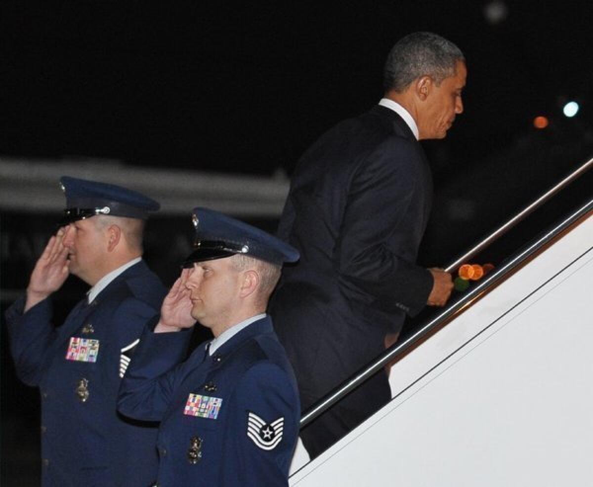 President Obama boards Air Force One on Tuesday at Andrews Air Force Base in Maryland. He returned to Hawaii to continue his vacation which he interrupted to deal with the "fiscal cliff" crisis.